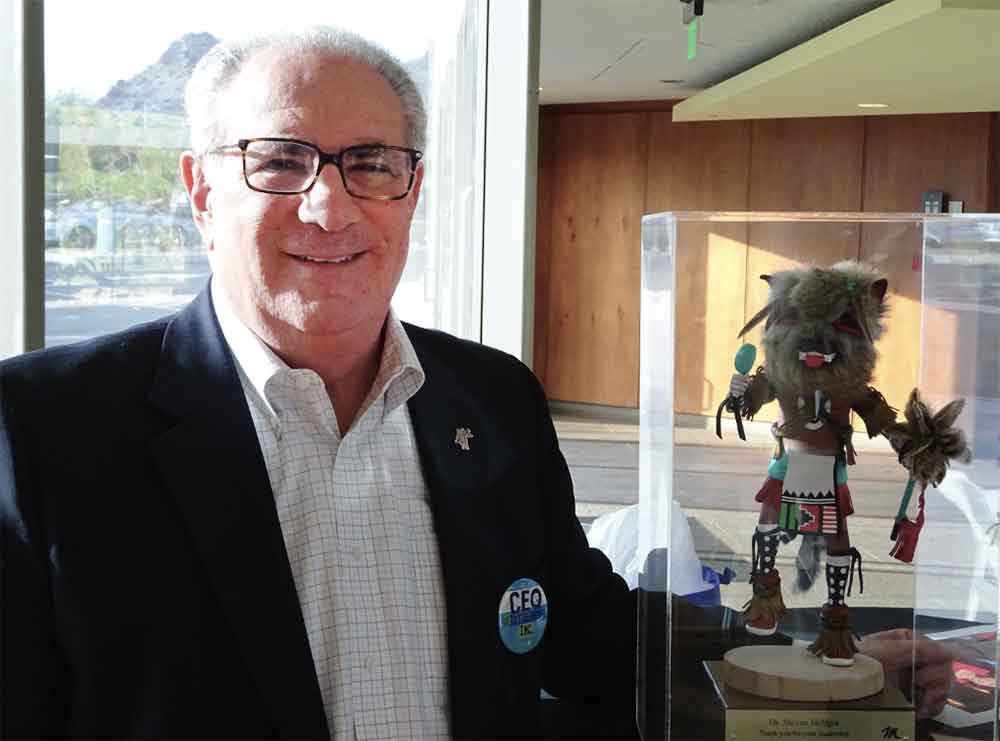 Dr. Steven Helfgot with kachina doll at his retirement party.