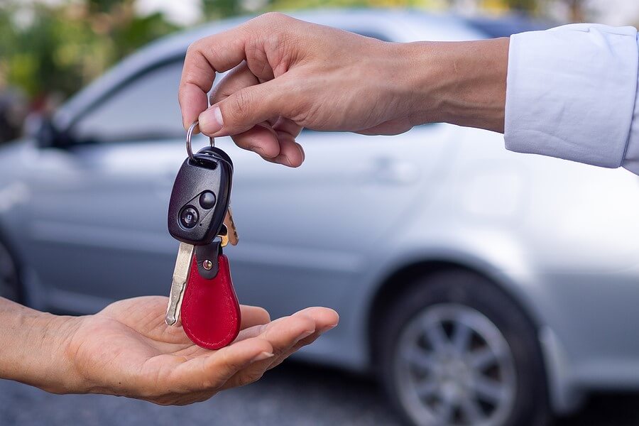 Person handing over car keys